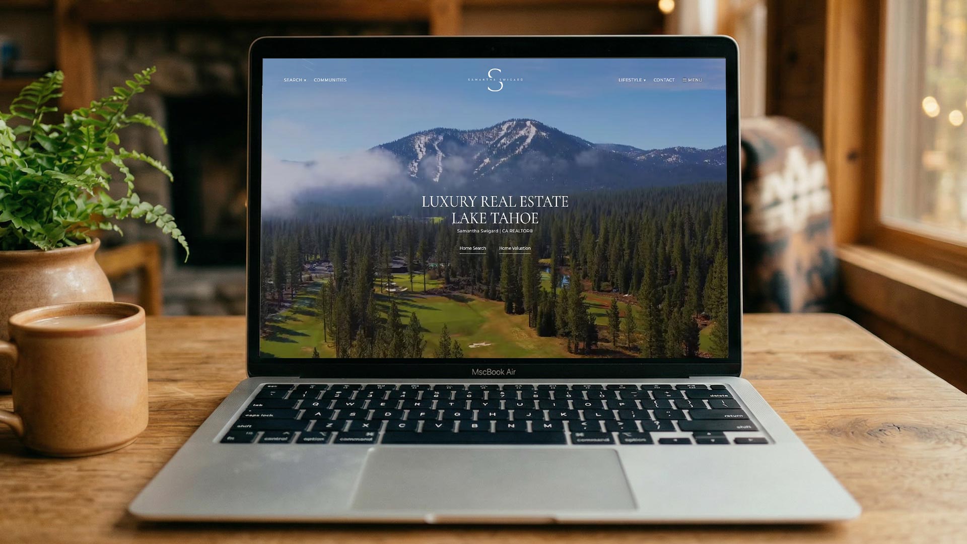 laptop on desk with real estate website
